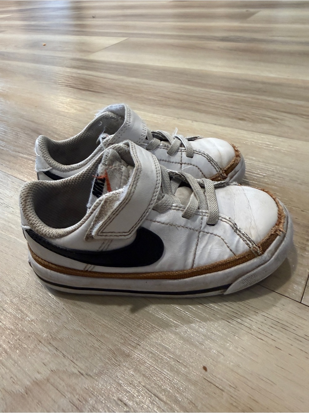 Nike Kids White Sneakers with Black Swoosh and Brown Trim